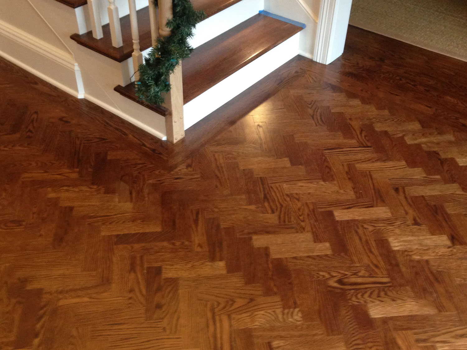 Warm-stained herringbone hardwood floor